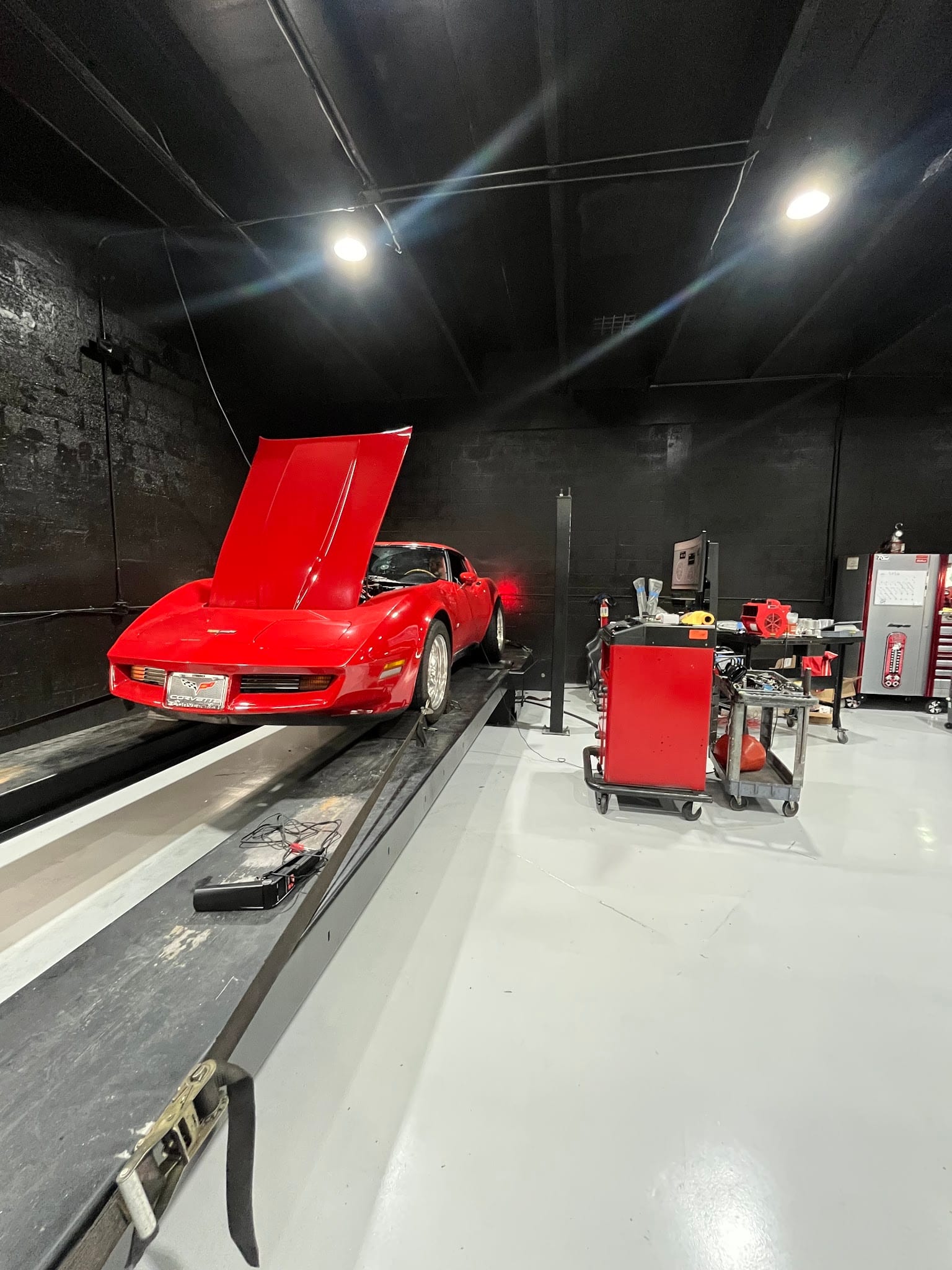 A red C3 Corvette strapped to the dyno at Custom Speed Creations