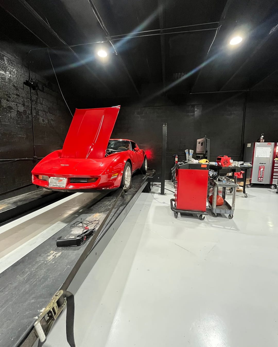 A red C3 Corvette strapped to the dyno at Custom Speed Creations in Cutler Bay